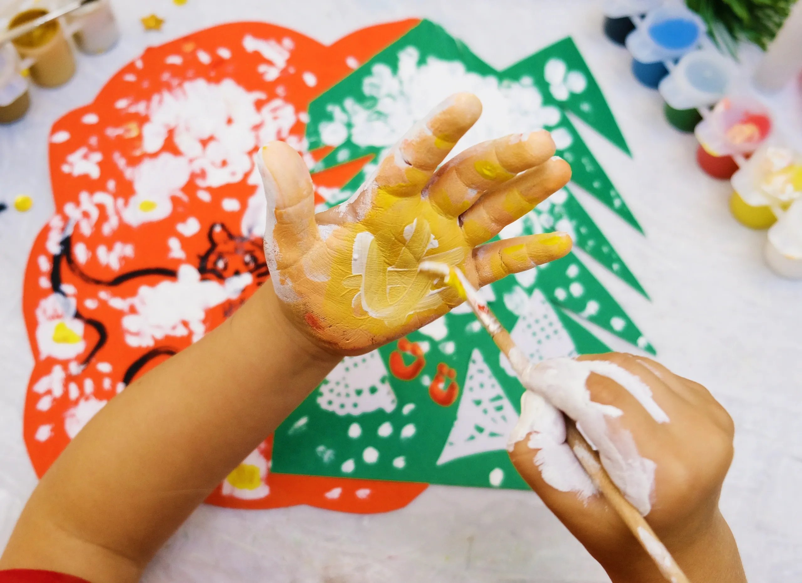 Child painting with hands — creative play therapy